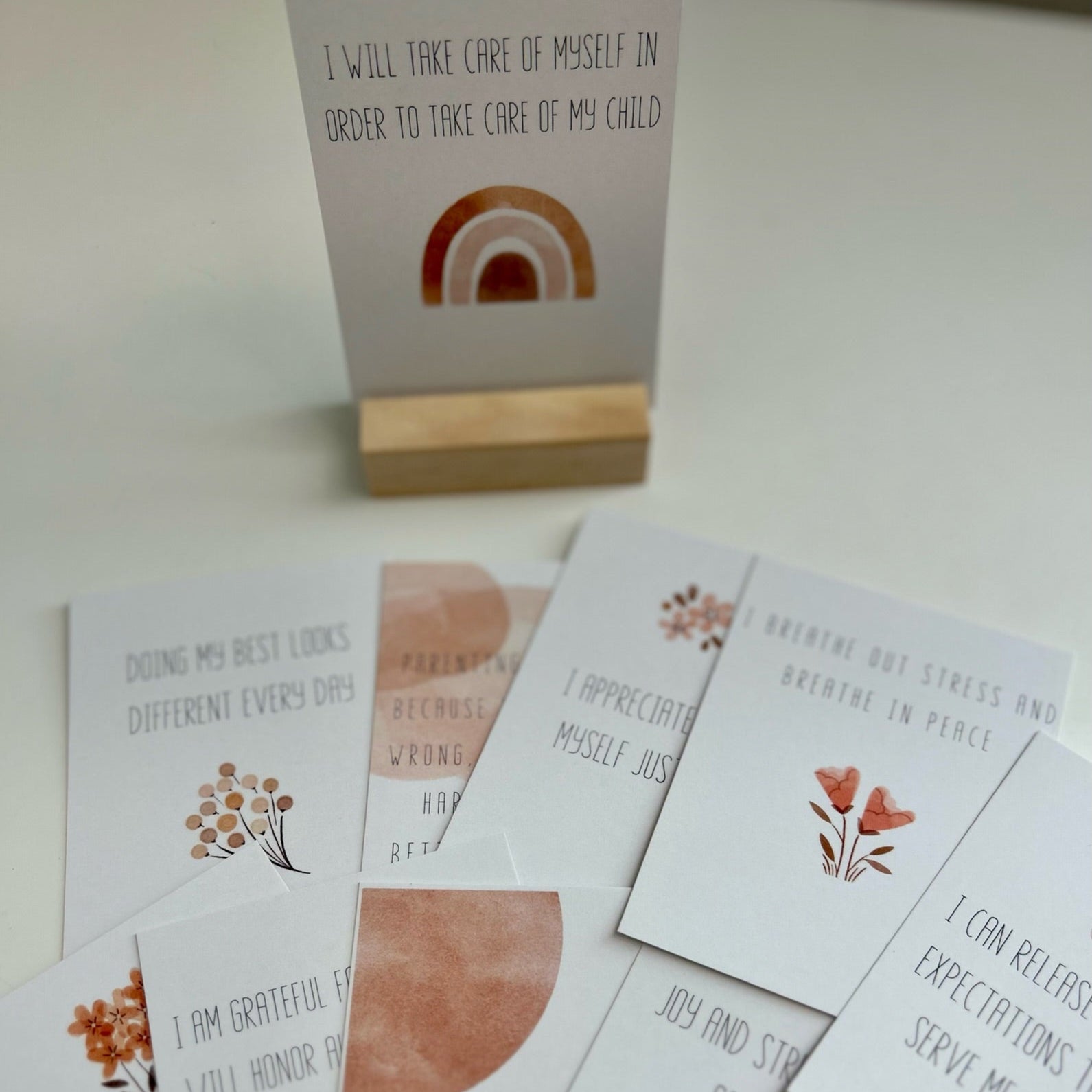 A calming and minimalist set of affirmation cards for new mothers, promoting mental wellness, gratitude, and realistic parenting expectations through gentle quotes and neutral design elements.