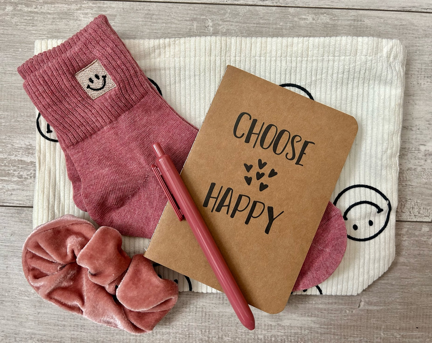 Send positive vibes with our Happy Vibes gift box. Includes happiness journal, smiley face bag, pen, scrunchie, and smiley face socks.