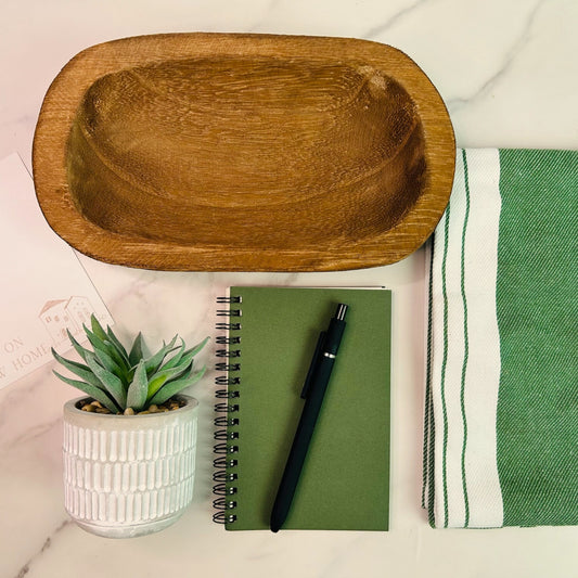 Realtor client gift set featuring succulent in white ceramic pot, green striped towel, wooden dish, and “Congrats on Your New Home” card.
