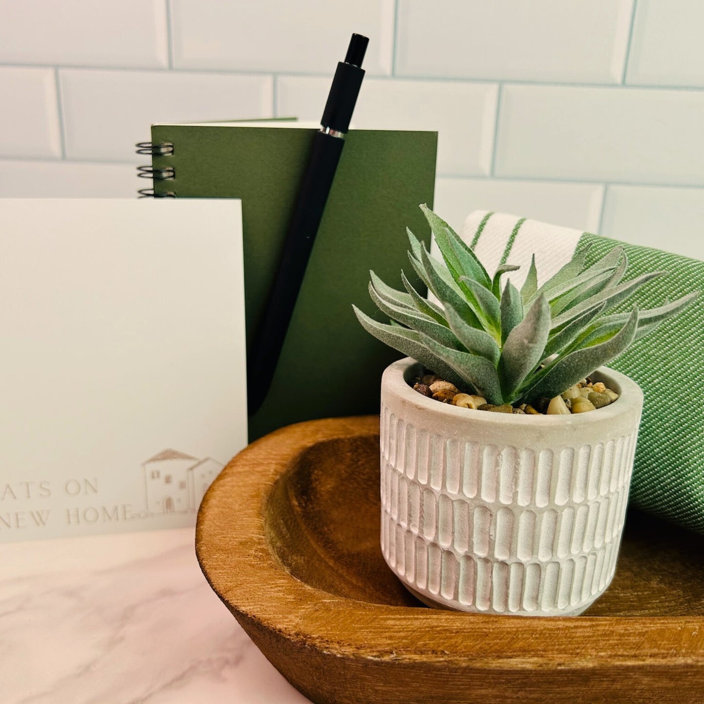 Modern succulent gift set for realtors to give clients, including potted plant, green towel, notebook, pen, and new home greeting card.