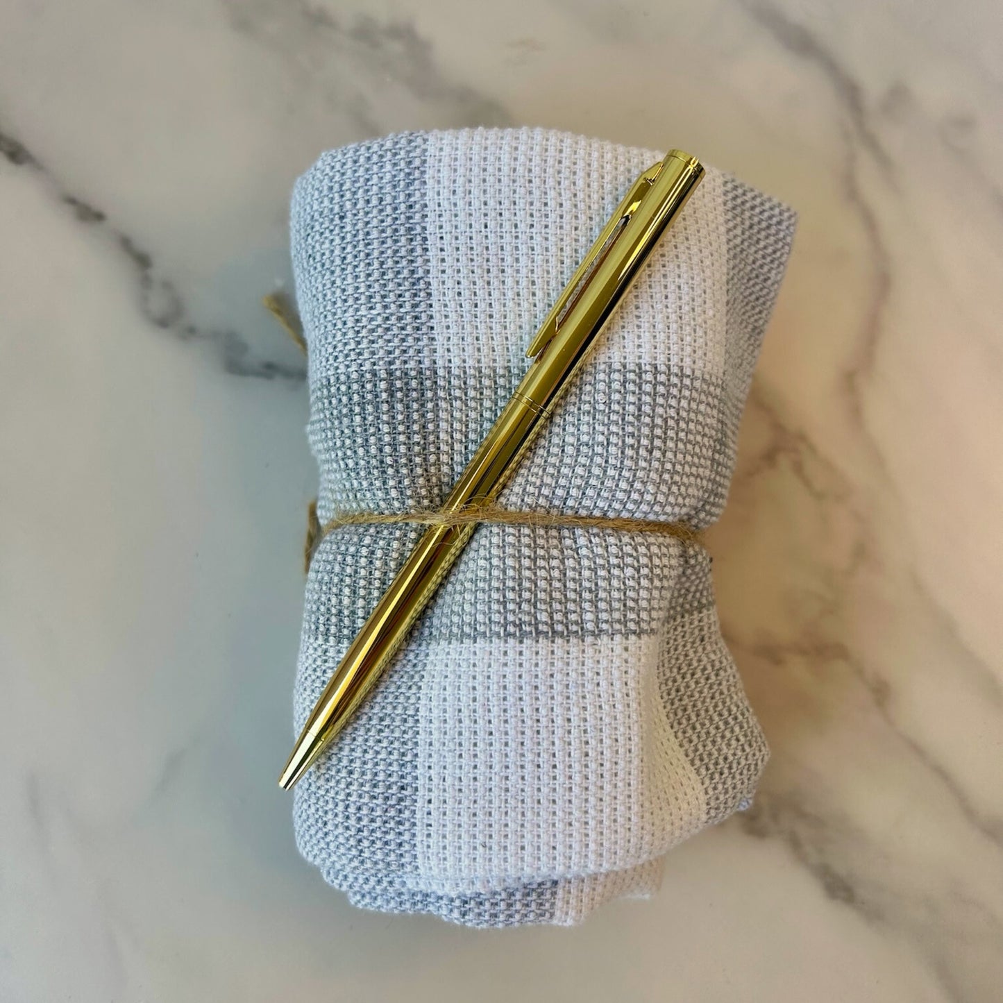 Closing gift with washcloth and gold pen