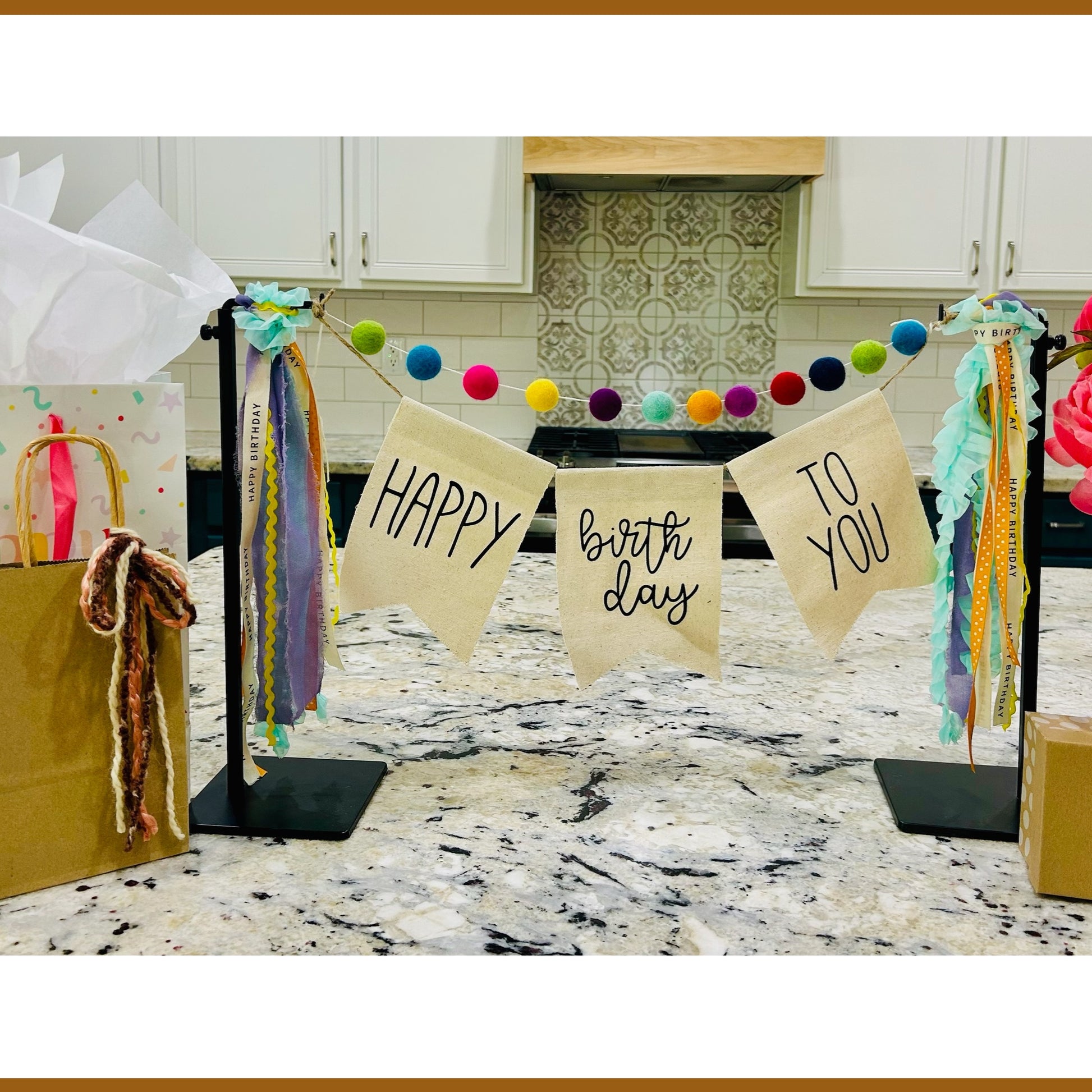 decorative birthday banner with felt balls, ribbon and banner perfect for a client birthday gift