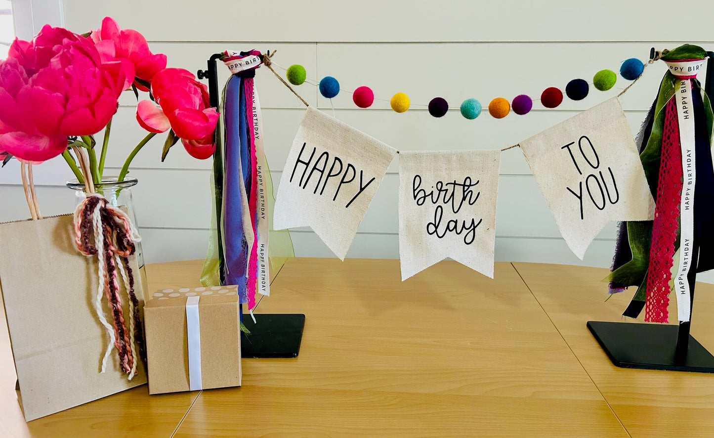 decorative birthday banner with felt balls, ribbon and banner perfect for a client birthday gift
