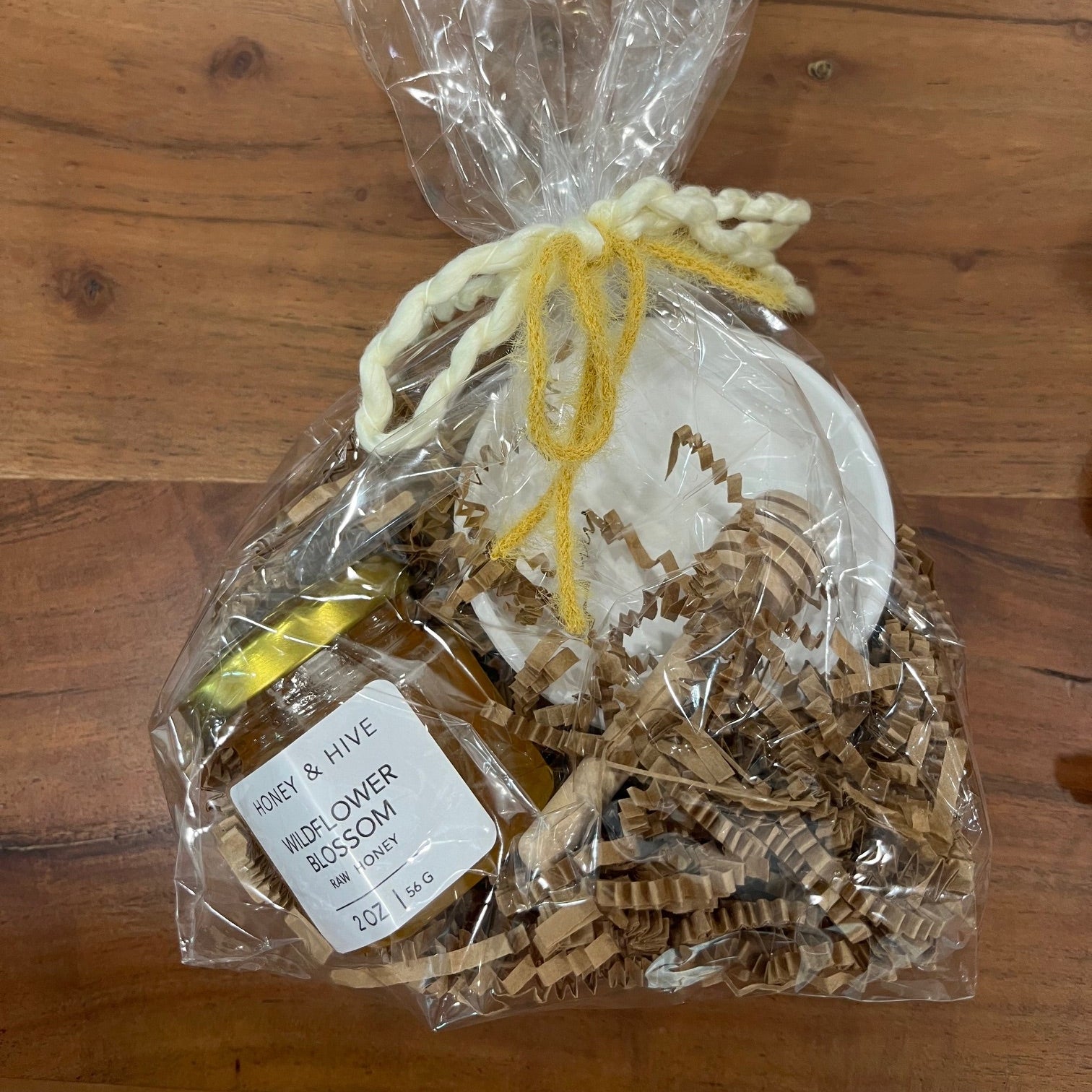 cute realtor check in gift for clients that includes honey a stir stick and small dish
