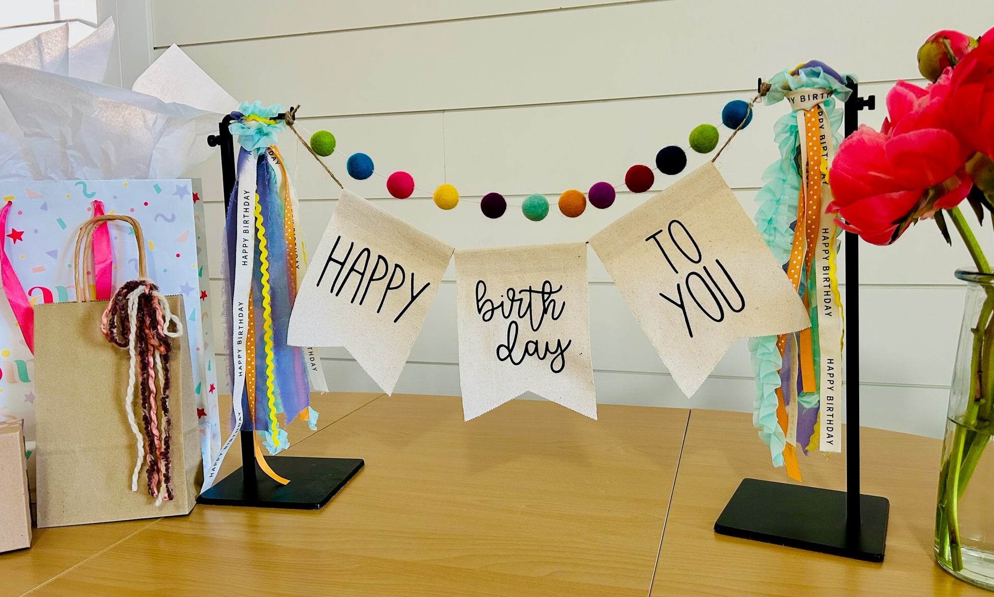 decorative birthday banner with felt balls, ribbon and banner perfect for a client birthday gift
