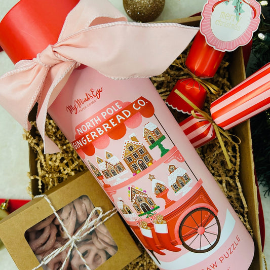 Gift box with north pole gingerbread puzzle, strawberry pretzels and Christmas crackers